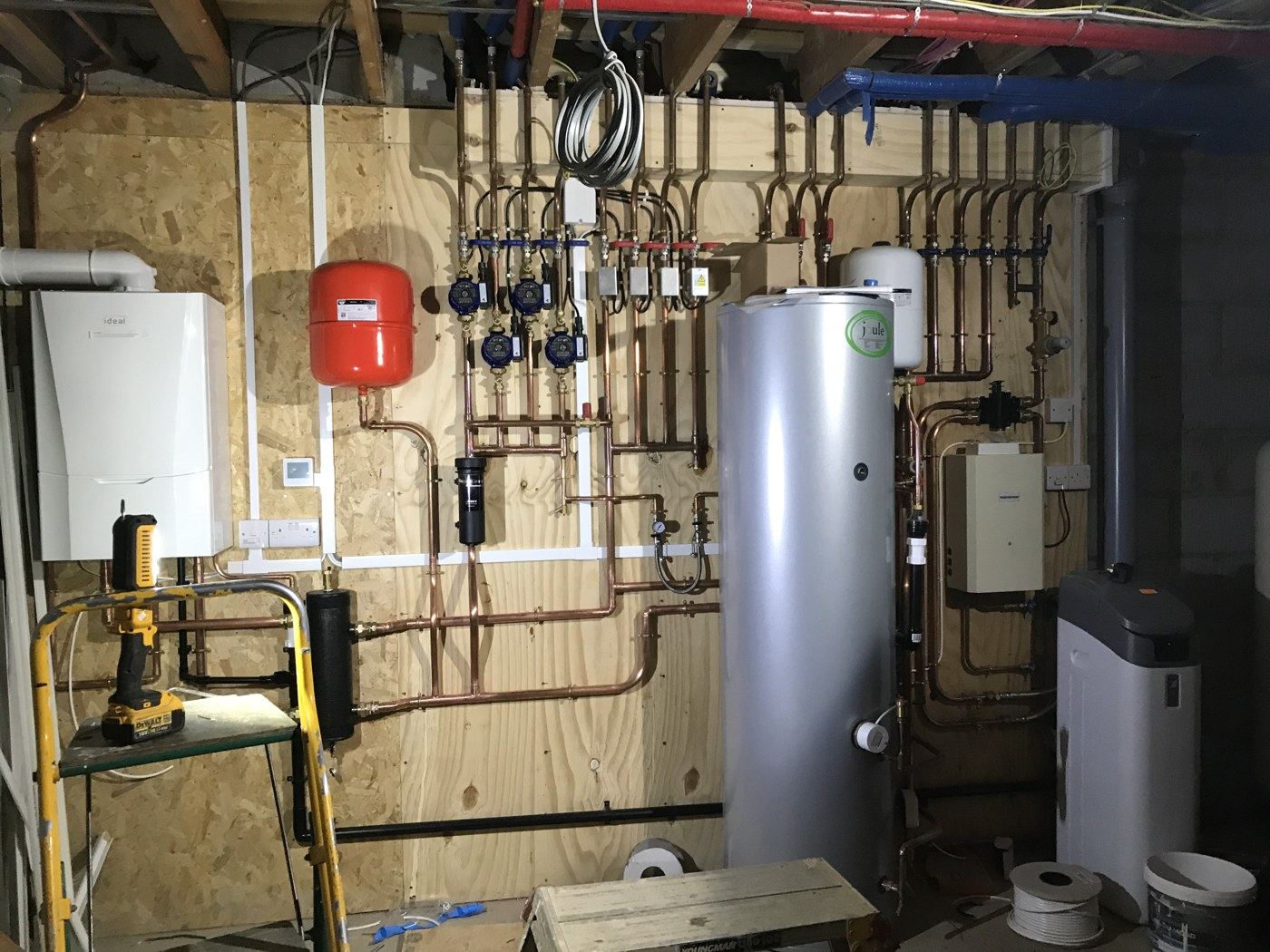 Boiler, cylinder, water softener and heating manifold set out together on one wall